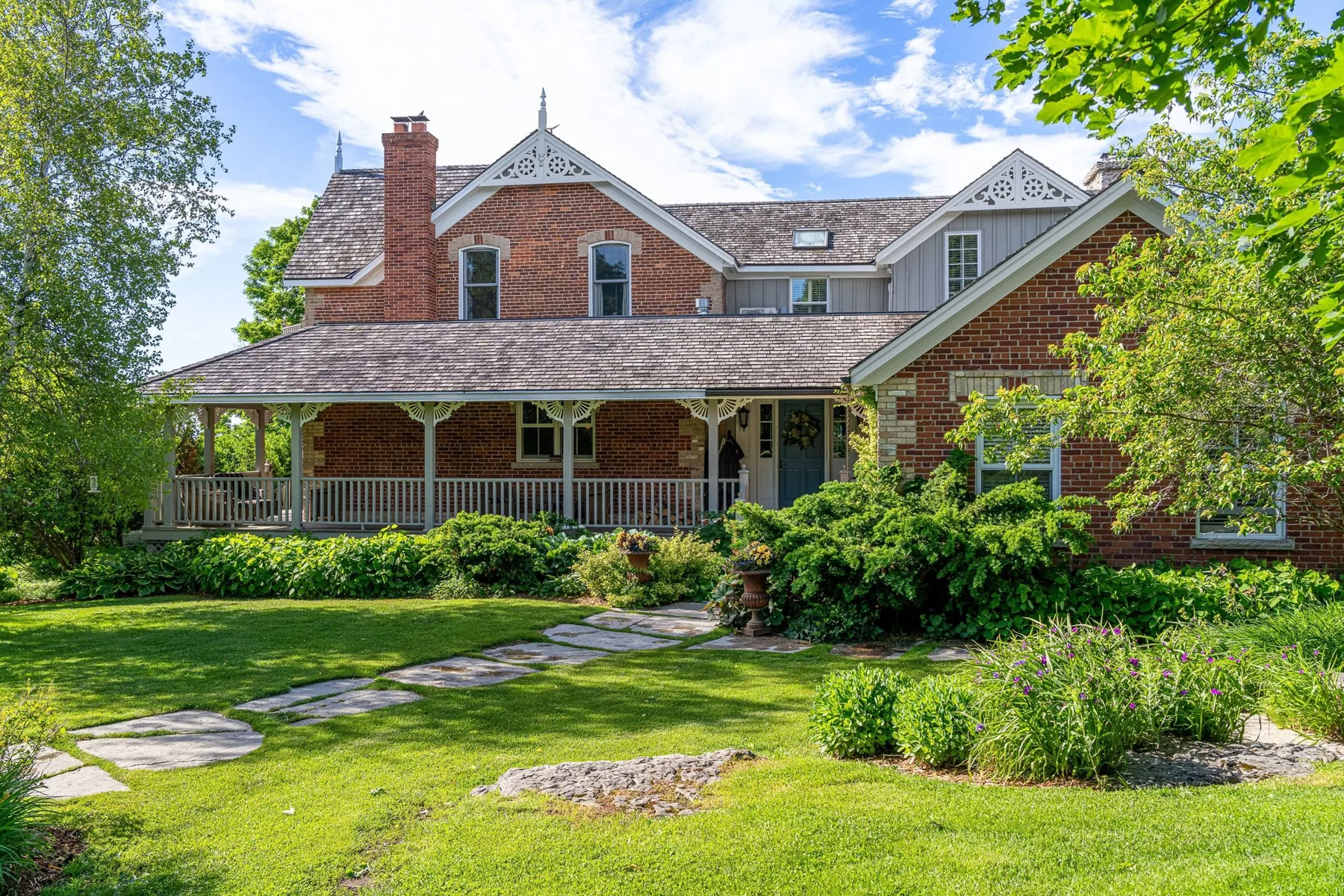 The farmhouse framed by summer gardens
